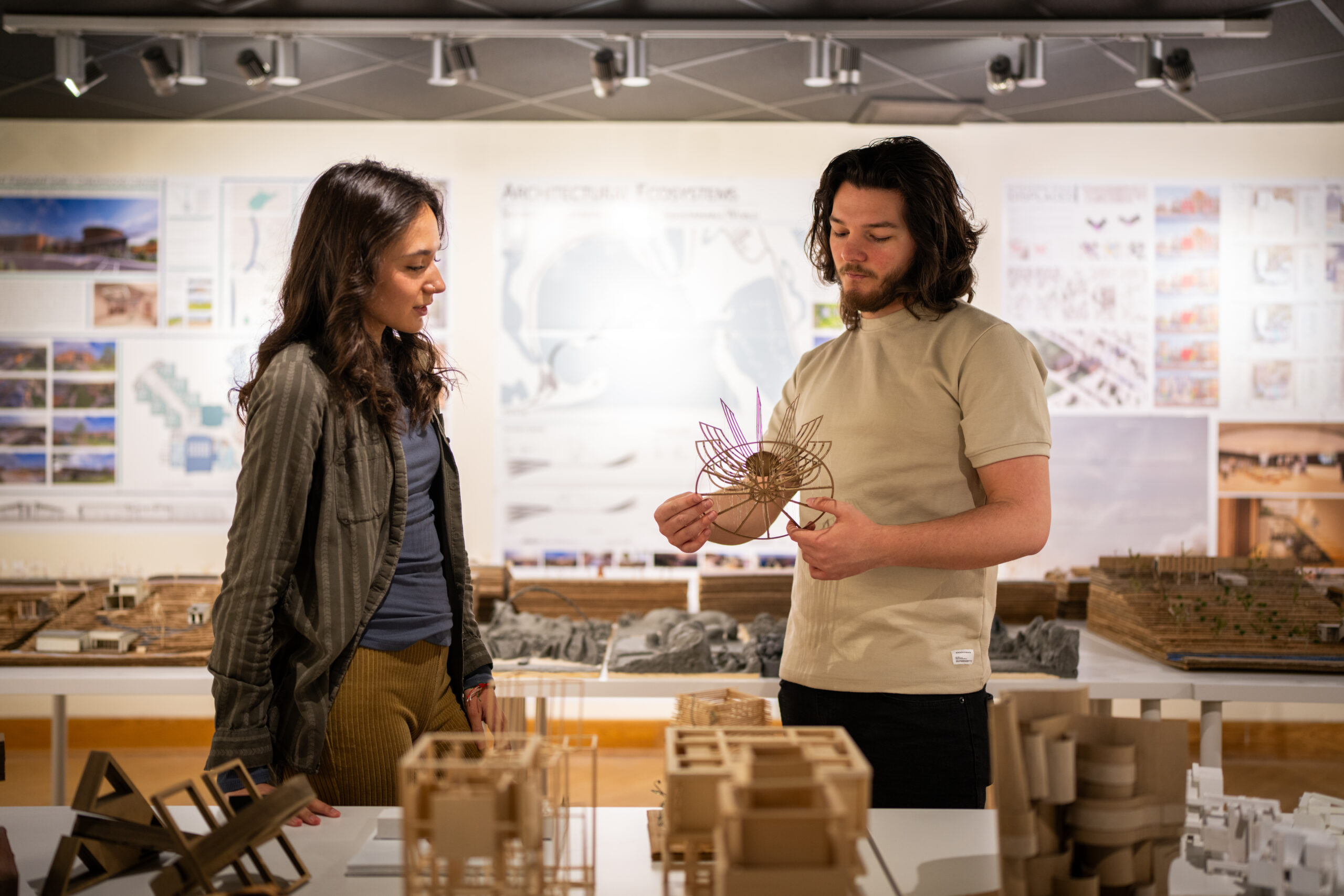 Architecture student presenting a project model.